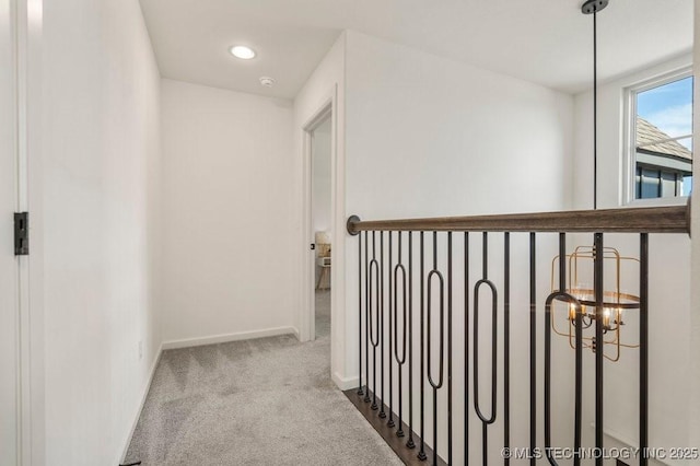 16804 E 43rd St S, Tulsa, OK 74134 - corridor featuring an inviting chandelier, carpet floors, and baseboards