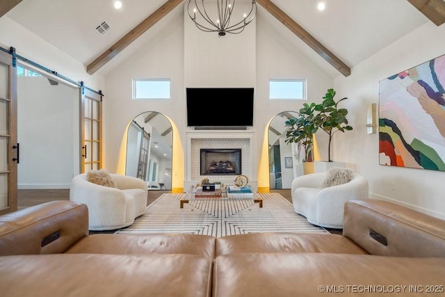 16804 E 43rd St S, Tulsa, OK 74134 - living room with baseboards, a barn door, high vaulted ceiling, and visible vents