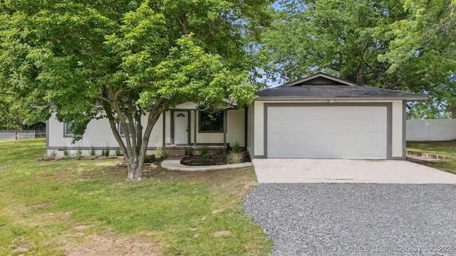 4010 E Harris, Muskogee, OK 74403 - view of front of home with driveway, a front yard, fence, and an attached garage