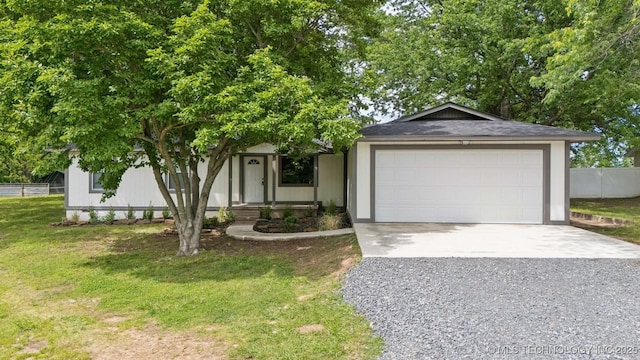 4010 E Harris, Muskogee, OK 74403 - view of front of home with an attached garage, driveway, fence, and a front lawn