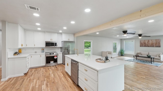 4010 E Harris, Muskogee, OK 74403 - kitchen with light wood-style floors, visible vents, open floor plan, and appliances with stainless steel finishes