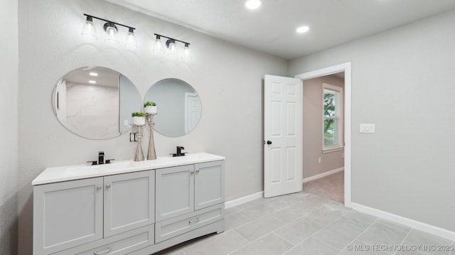 4010 E Harris, Muskogee, OK 74403 - bathroom featuring baseboards, recessed lighting, double vanity, and a sink