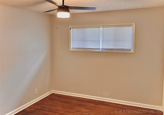empty room with baseboards, a textured ceiling, a ceiling fan, and dark wood-style floors