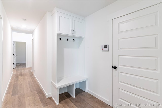 mudroom with light wood-style flooring and baseboards