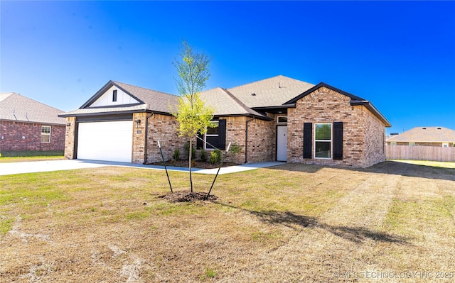 ranch-style house with brick siding, driveway, fence, and a front yard