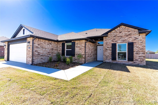 single story home featuring a front lawn, brick siding, and an attached garage
