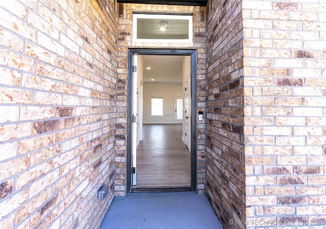 property entrance featuring brick siding