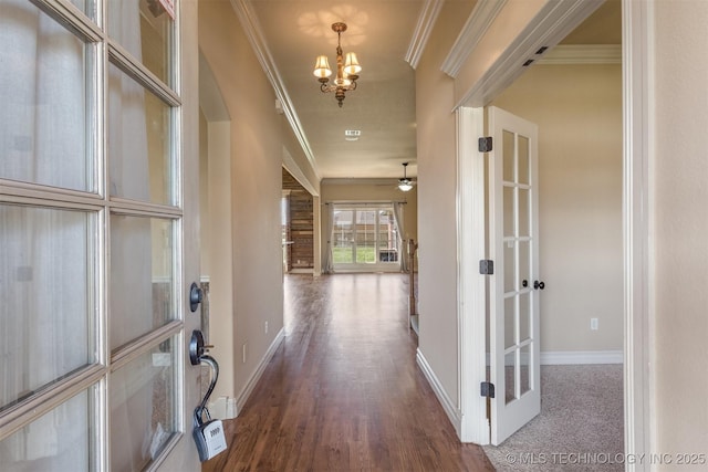 entrance foyer featuring french doors, baseboards, ornamental molding, dark wood finished floors, and ceiling fan with notable chandelier