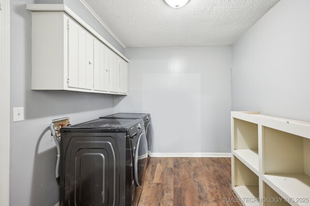 1109 S Division St, Sapulpa, OK 74066 - washroom featuring cabinet space, a textured ceiling, washer and clothes dryer, baseboards, and dark wood-style floors