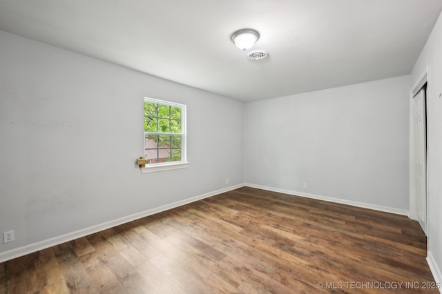 1109 S Division St, Sapulpa, OK 74066 - unfurnished bedroom featuring baseboards, visible vents, and wood finished floors