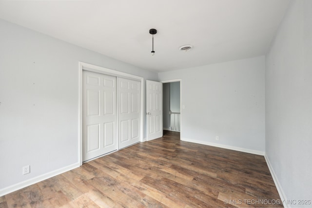 1109 S Division St, Sapulpa, OK 74066 - unfurnished bedroom featuring wood finished floors, visible vents, and baseboards