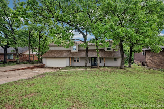 1109 S Division St, Sapulpa, OK 74066 - view of front of house with driveway, french doors, a garage, stucco siding, and a front lawn