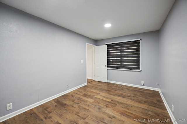 1109 S Division St, Sapulpa, OK 74066 - unfurnished bedroom featuring baseboards, wood finished floors, and recessed lighting