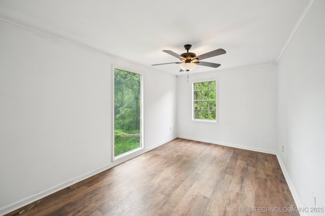 1109 S Division St, Sapulpa, OK 74066 - spare room featuring a ceiling fan, ornamental molding, wood-type flooring, and baseboards