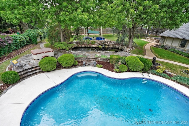 view of swimming pool with fence and a patio