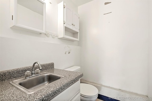 bathroom featuring toilet and vanity