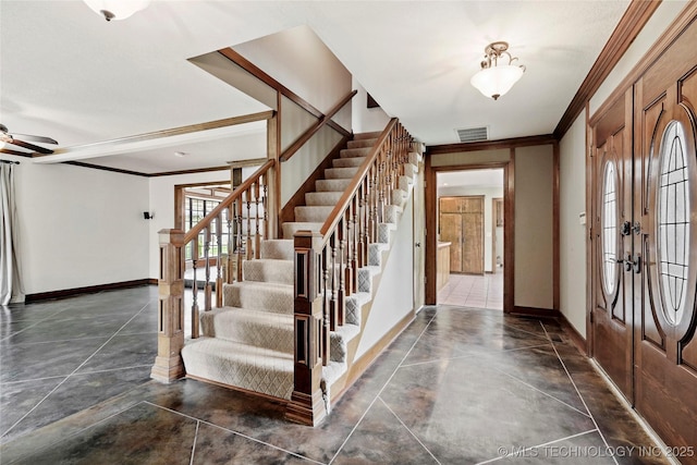 entryway with stairway, ornamental molding, baseboards, ceiling fan, and french doors