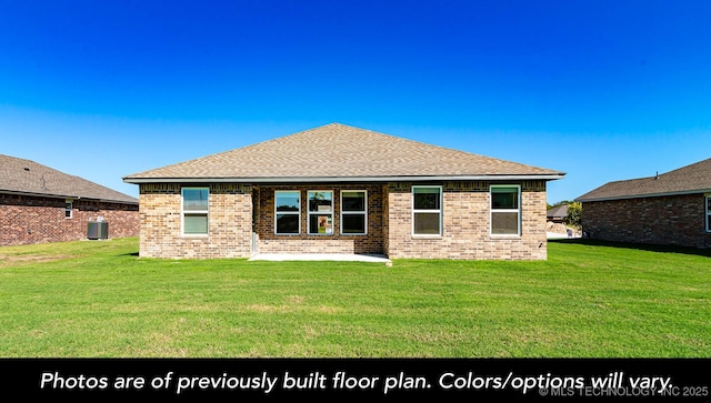 back of house featuring a yard, a patio area, and brick siding