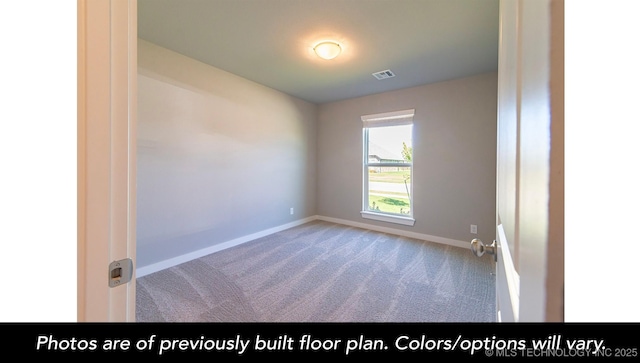 carpeted spare room with visible vents and baseboards