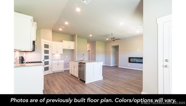 kitchen with a sink, light wood-type flooring, ceiling fan, appliances with stainless steel finishes, and decorative backsplash