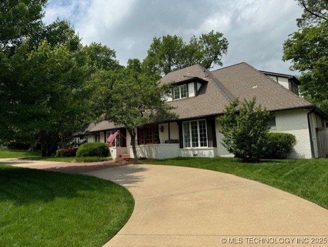 3421 E 62nd St, Tulsa, OK 74136 - view of front of house with a front lawn, brick siding, curved driveway, and a shingled roof