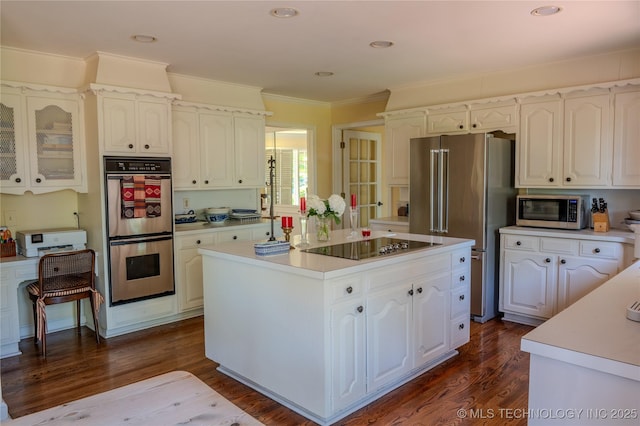3421 E 62nd St, Tulsa, OK 74136 - kitchen featuring appliances with stainless steel finishes, white cabinetry, light countertops, dark wood finished floors, and crown molding