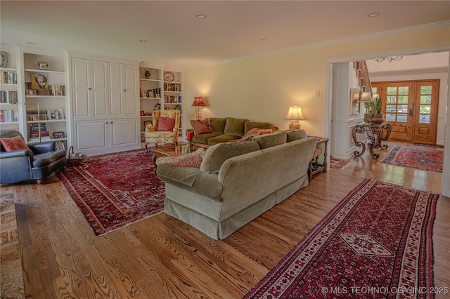 3421 E 62nd St, Tulsa, OK 74136 - living area with wood finished floors, crown molding, french doors, and built in features