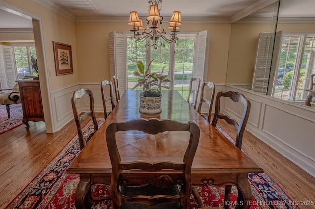 3421 E 62nd St, Tulsa, OK 74136 - dining room featuring light wood-type flooring, a chandelier, a wainscoted wall, ornamental molding, and a decorative wall