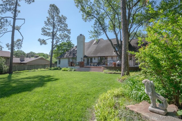 3421 E 62nd St, Tulsa, OK 74136 - rear view of property with a chimney and a deck