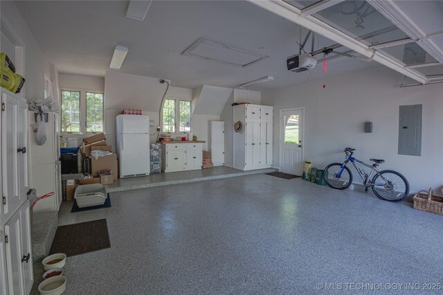 3421 E 62nd St, Tulsa, OK 74136 - garage with freestanding refrigerator, electric panel, and a garage door opener