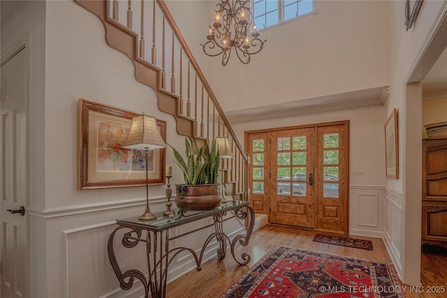 3421 E 62nd St, Tulsa, OK 74136 - entrance foyer with stairs, wood finished floors, plenty of natural light, a decorative wall, and a wainscoted wall