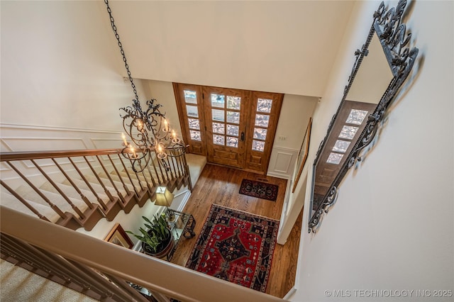 3421 E 62nd St, Tulsa, OK 74136 - foyer with wood finished floors, a chandelier, and stairs