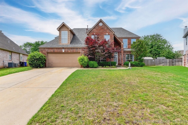 traditional-style house with a garage, fence, central air condition unit, a shingled roof, and brick siding