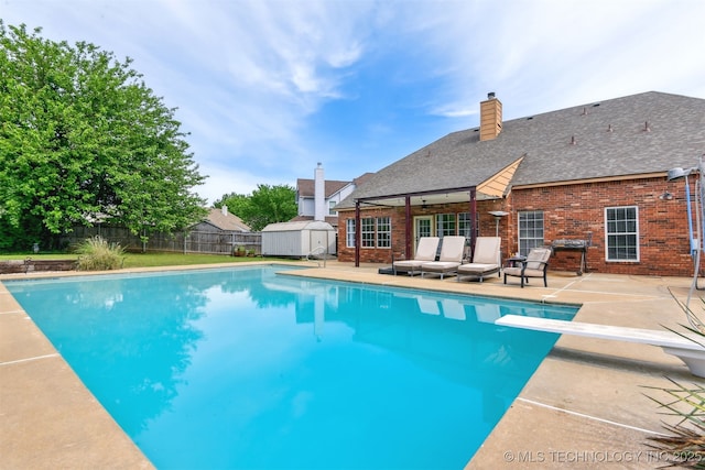 view of pool with an outbuilding, a fenced in pool, a shed, a patio, and a fenced backyard
