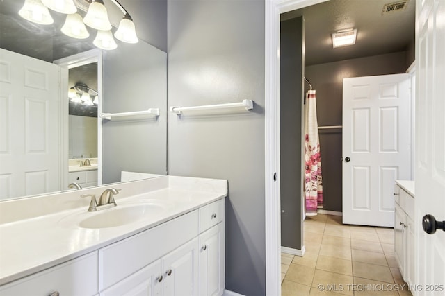 full bathroom featuring baseboards, visible vents, tile patterned flooring, and vanity