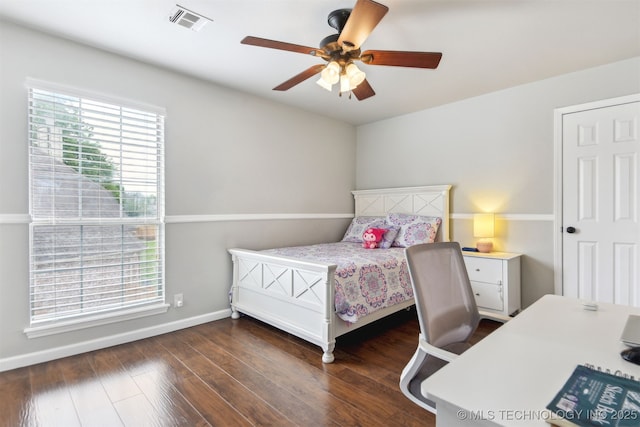 bedroom featuring wood finished floors, visible vents, baseboards, and ceiling fan