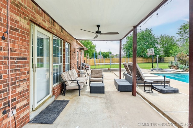 view of patio featuring an outdoor living space, a fenced in pool, ceiling fan, and a fenced backyard