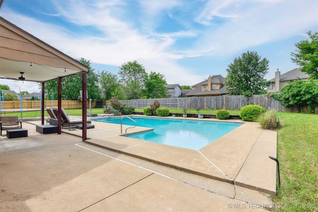 view of swimming pool with a patio area, a fenced backyard, a fenced in pool, a lawn, and outdoor lounge area