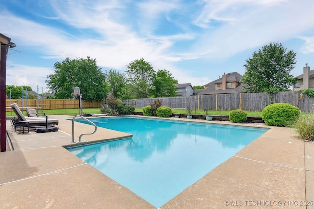 view of swimming pool featuring a patio, a fenced in pool, and a fenced backyard