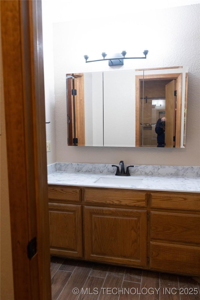 bathroom featuring wood tiled floor and vanity