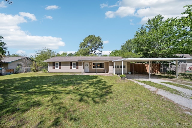 141 S Bryan St, Copan, OK 74022 - ranch-style house featuring fence, driveway, a garage, a front yard, and a carport