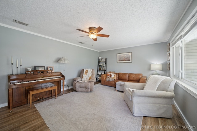 141 S Bryan St, Copan, OK 74022 - living room featuring visible vents, ceiling fan, a textured ceiling, and wood finished floors