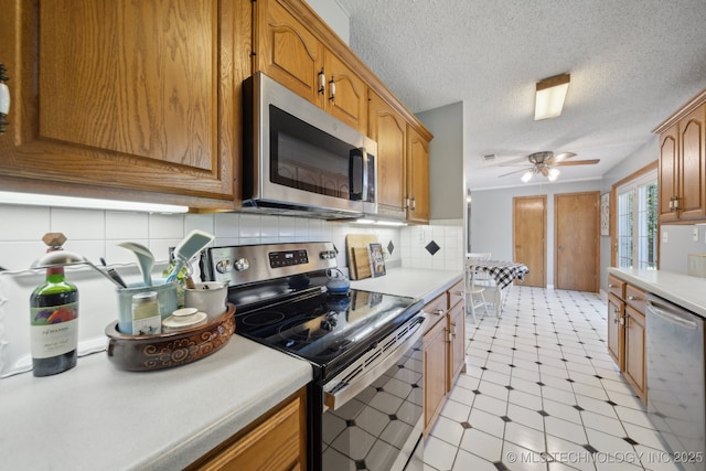 141 S Bryan St, Copan, OK 74022 - kitchen with stainless steel appliances, light floors, light countertops, a ceiling fan, and decorative backsplash