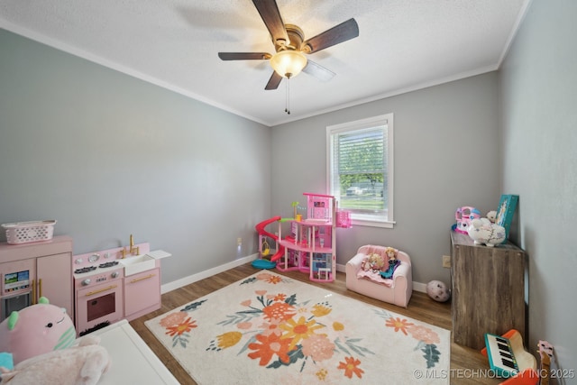 141 S Bryan St, Copan, OK 74022 - rec room featuring crown molding, baseboards, wood finished floors, and a ceiling fan