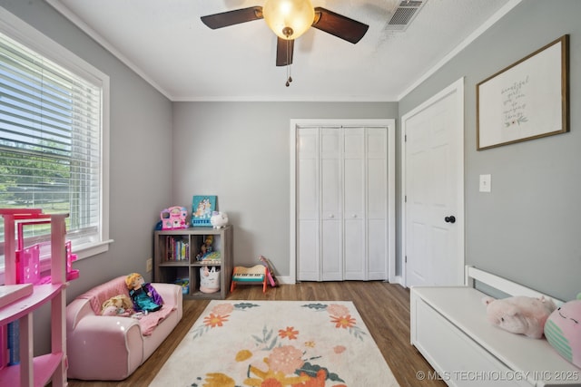 141 S Bryan St, Copan, OK 74022 - rec room featuring visible vents, wood finished floors, a ceiling fan, and ornamental molding