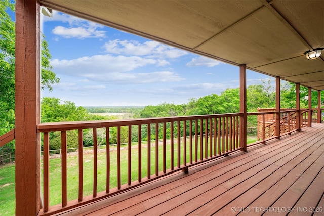 wooden terrace featuring a yard