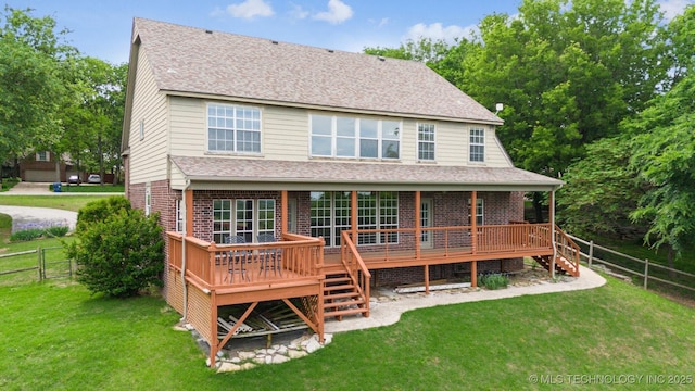 back of house with a deck, a lawn, a fenced backyard, and stairs