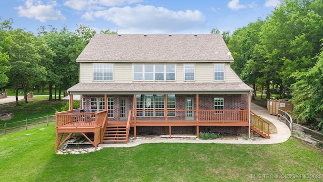 back of house with stairway, a lawn, fence, and a deck