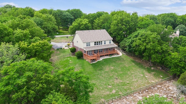 birds eye view of property with a wooded view