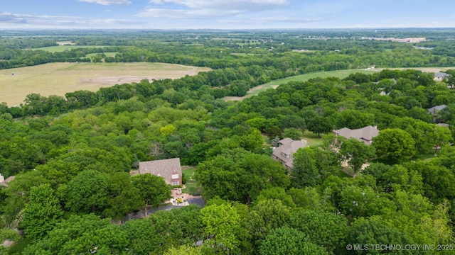 bird's eye view with a wooded view